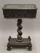An 18th century and later carved oak jardiniere. 67.5 cm wide.