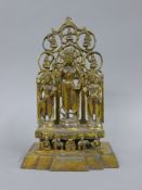 A gilt bronze shrine set with three deities. 28 cm high.