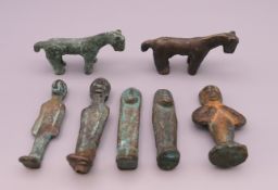 Seven early bronze and iron votive figures. The largest 7 cm high.