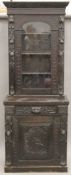 A Victorian carved oak side cabinet. 71.5 cm wide.