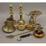 A quantity of various brassware, including candlesticks and a bell.