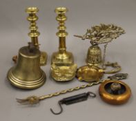 A quantity of various brassware, including candlesticks and a bell.