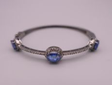 A kyanite and diamond silver bangle; together with a World Gemological Institute Gemological Report.