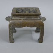 A Chinese bronze censer with dog-of-fo handles. 10 cm high.