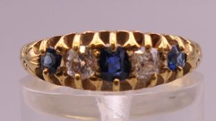 An 18 ct gold diamond and sapphire ring. Ring size L. 3.5 grammes total weight.