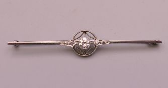 An unmarked white gold or platinum diamond bar brooch. 6.5 cm long. 3.8 grammes total weight.