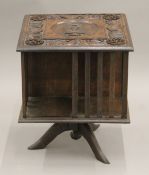 An Eastern carved table top revolving bookcase. 42 cm high.