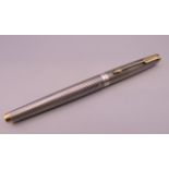 A silver cased Parker fountain pen with 18 ct gold nib.