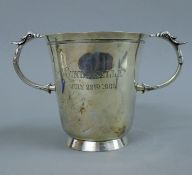A twin handled silver trophy cup, inscribed Cinderella July 22nd 1905. 14.5 cm high. 16.