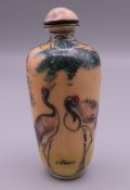 A signed Canton cloisonne snuff bottle decorated with storks. 6.5 cm high.