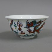 A Chinese porcelain bowl decorated with dragons. 12 cm diameter.