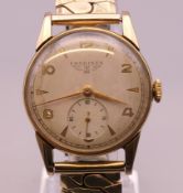 A 9 ct gold cased Longines gentlemen's wristwatch on a plated strap. 3.5 cm wide.