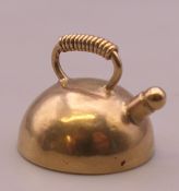 A 9 ct gold charm formed as a kettle. 1.9 grammes.