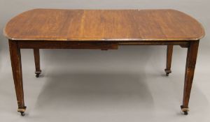 An oak dining table. Approximately 169 cm long.