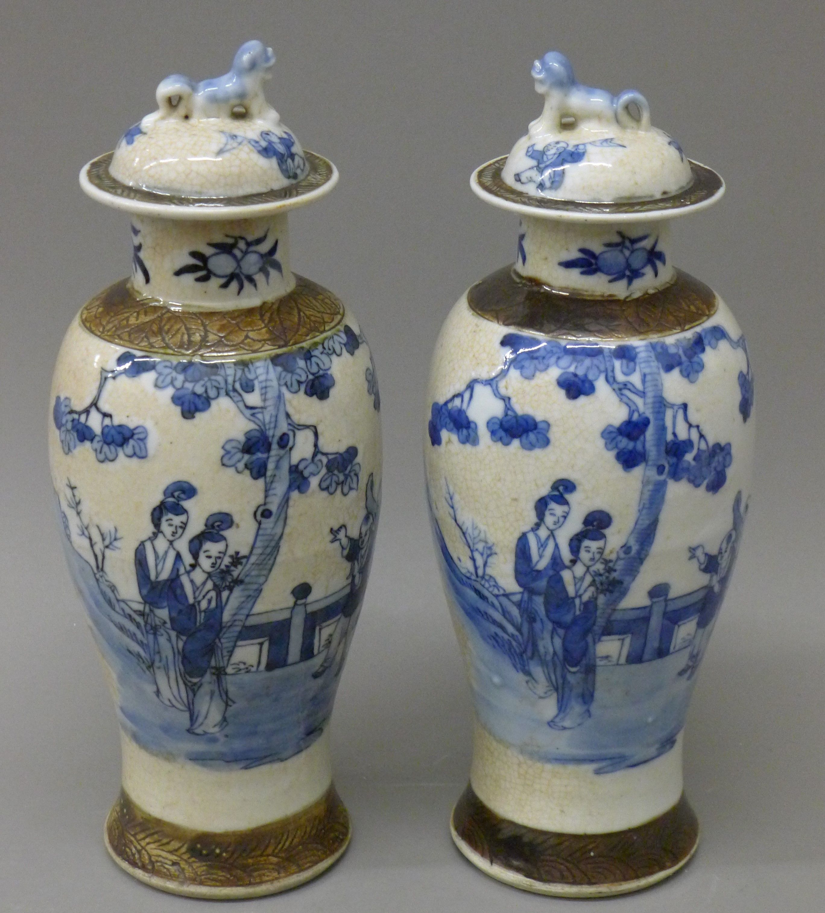 A pair of 19th century Chinese blue and white baluster vases and covers decorated with figures, etc.