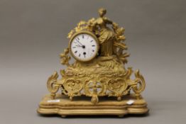 A Victorian gilt spelter mantle clock on a plinth base. 33 cm high.