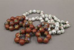 Two cloisonne bead necklaces. The largest (red necklace) approximately 74 cm long.