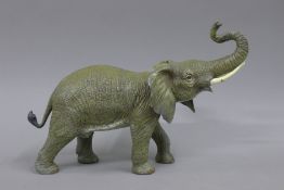 A cold painted bronze model of an elephant. 32 cm long.