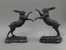 A pair of bronze boxing hares. 29 cm high.