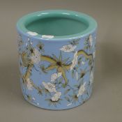 A Chinese blue ground porcelain brush pot. 19 cm high.