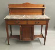 An Edwardian mahogany marble topped wash stand. 103 cm wide.