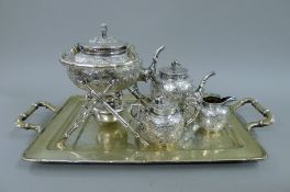 A Chinese silver four-piece tea set, together with an engraved Chinese silver tray. The tray 56.
