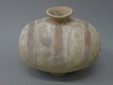 A Chinese cocoon jar, possibly Han Dynasty. 74 cm wide.