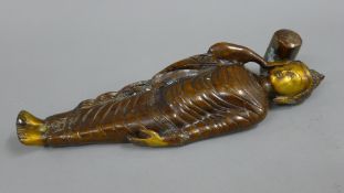 A bronze model of Buddha. 34 cm long.