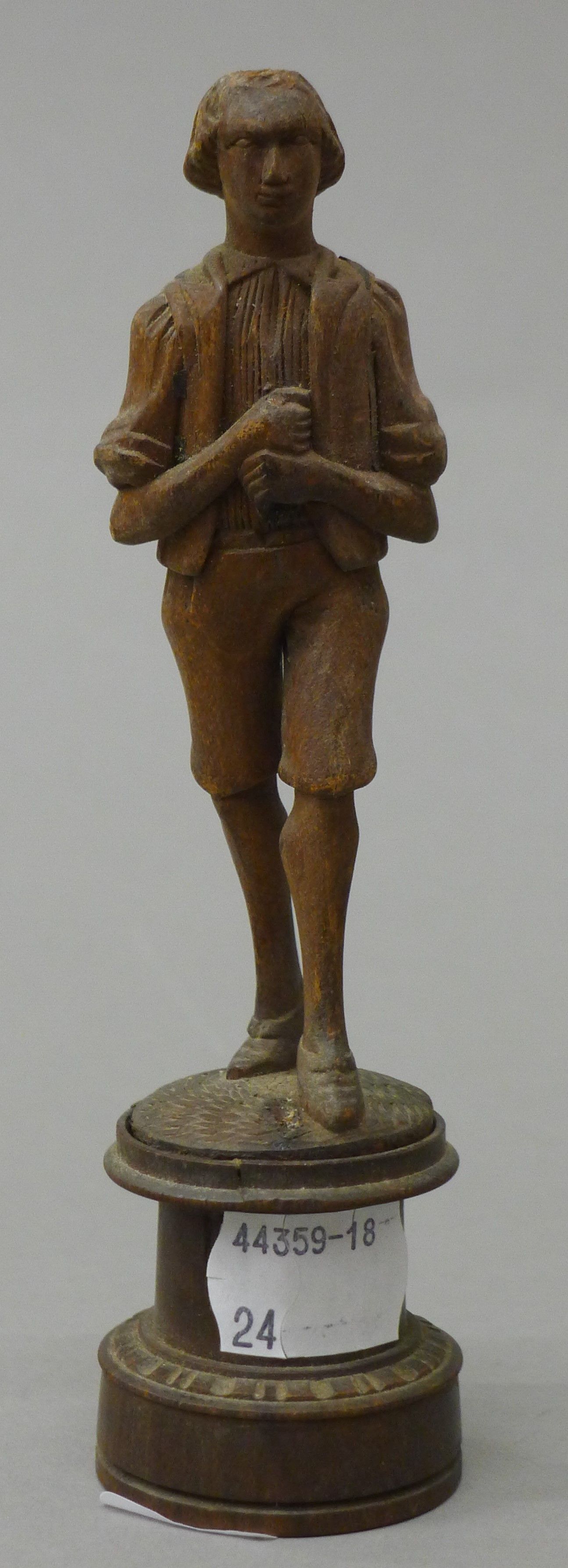 A Blackforest carved figure of a boy. 15 cm high.