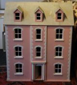 A large doll's house. 86 cm high x 73 cm wide.