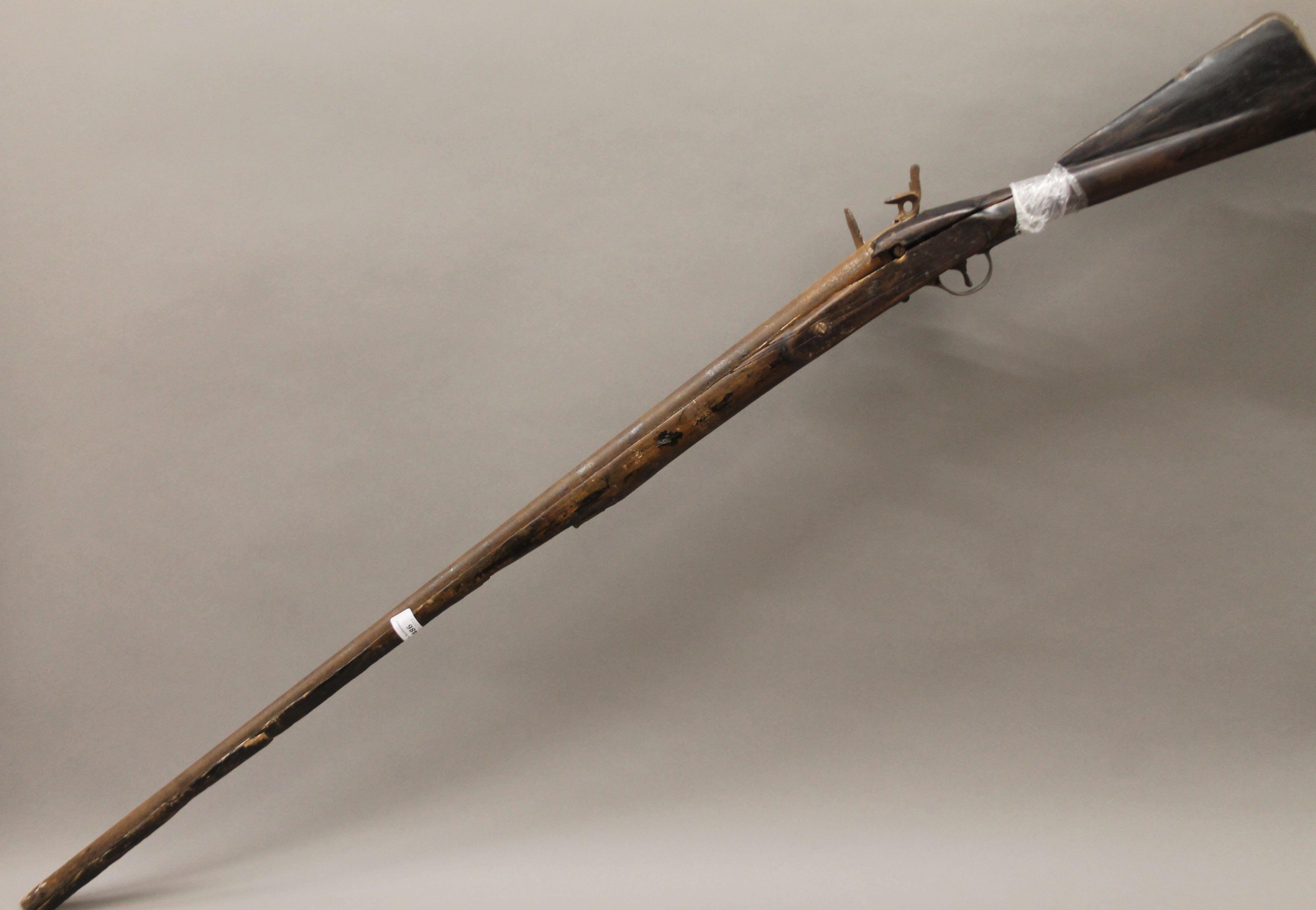 An antique flintlock musket. 138 cm long.