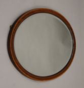 An Edwardian oval mirror. 82.5 cm wide, 57.5 cm high.