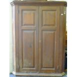 A Victorian pine corner cupboard. 153 cm high.