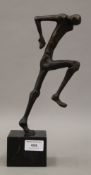 A contemporary bronze model of a running man on a black marble plinth base. 31.5 cm high overall.
