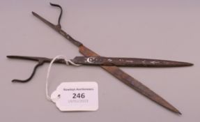 A pair of 17th/18th century steel scissors. 20 cm long.