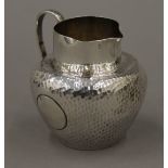 A silver cream jug. 8.5 cm high. 94.6 grammes.