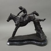 A bronze model of a horse and jockey. 36 cm long.