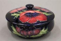 A boxed Moorcroft lidded pot. 12 cm diameter.