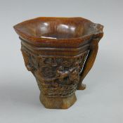 A libation cup. 13 cm high.