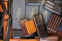 A quantity of leather cigar cases, including Ralph Lauren.