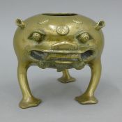 A 19th century Chinese bronze censer in the form of a three legged mythical beast. 13 cm high.