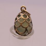 A silver egg formed pendant. 2 cm high.