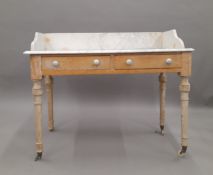 A Victorian marble topped pine wash stand. 107 cm wide.