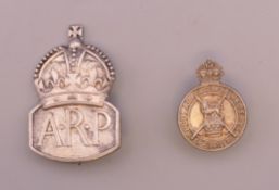 A silver A.R.P badge and a silver Regular Army Reserve badge.