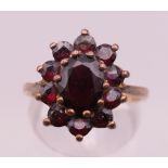 A 9 ct gold garnet ring. Ring size O. 3.5 grammes total weight.