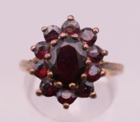 A 9 ct gold garnet ring. Ring size O. 3.5 grammes total weight.