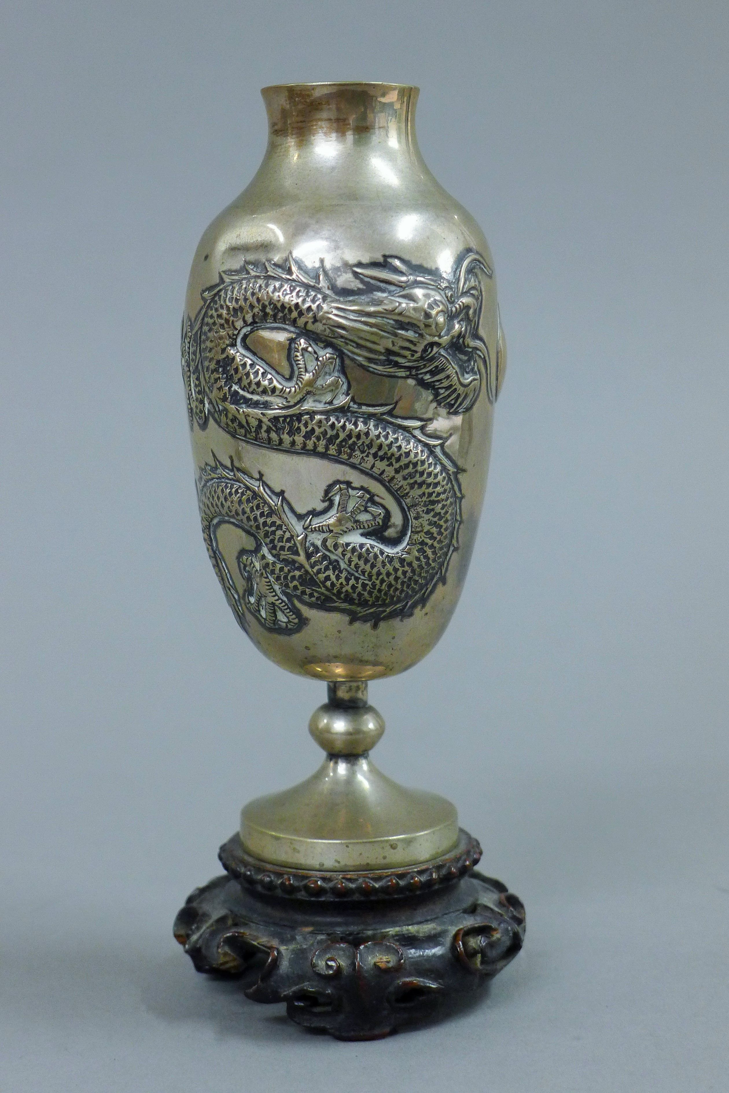 A pair of small Chinese silver vases, each mounted on a carved wooden stand. 14.5 cm high overall. - Image 3 of 5