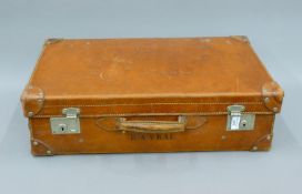 A vintage leather suitcase. 67 cm wide.