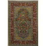 A framed and glazed miniature carpet. 28 x 38.5 cm overall.