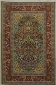 A framed and glazed miniature carpet. 28 x 38.5 cm overall.
